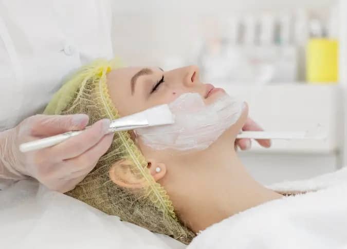 Female undergoing chemical peels treatment for skin rejuvenation at a beauty clinic